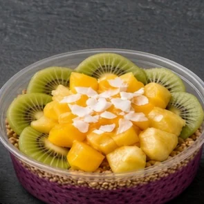 Mango Madness bowl: dragon fruit base with granola, mango and pineapple chunks, kiwi slices and honey